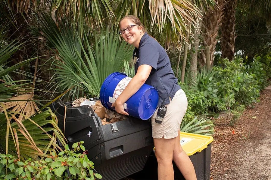 Zoo staff dumps waste into composter