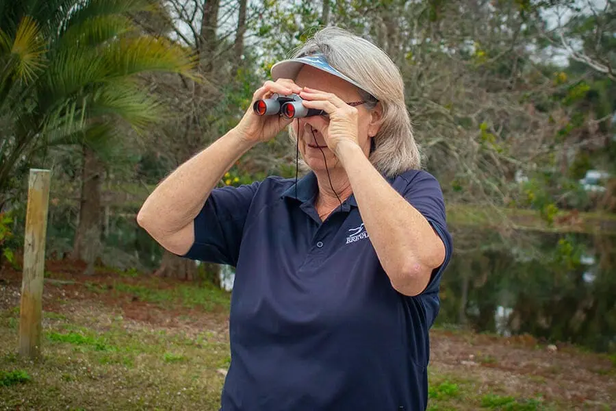 woman holding binoculars