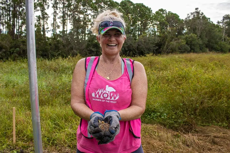 Laura Lee holds up wildflower seeds