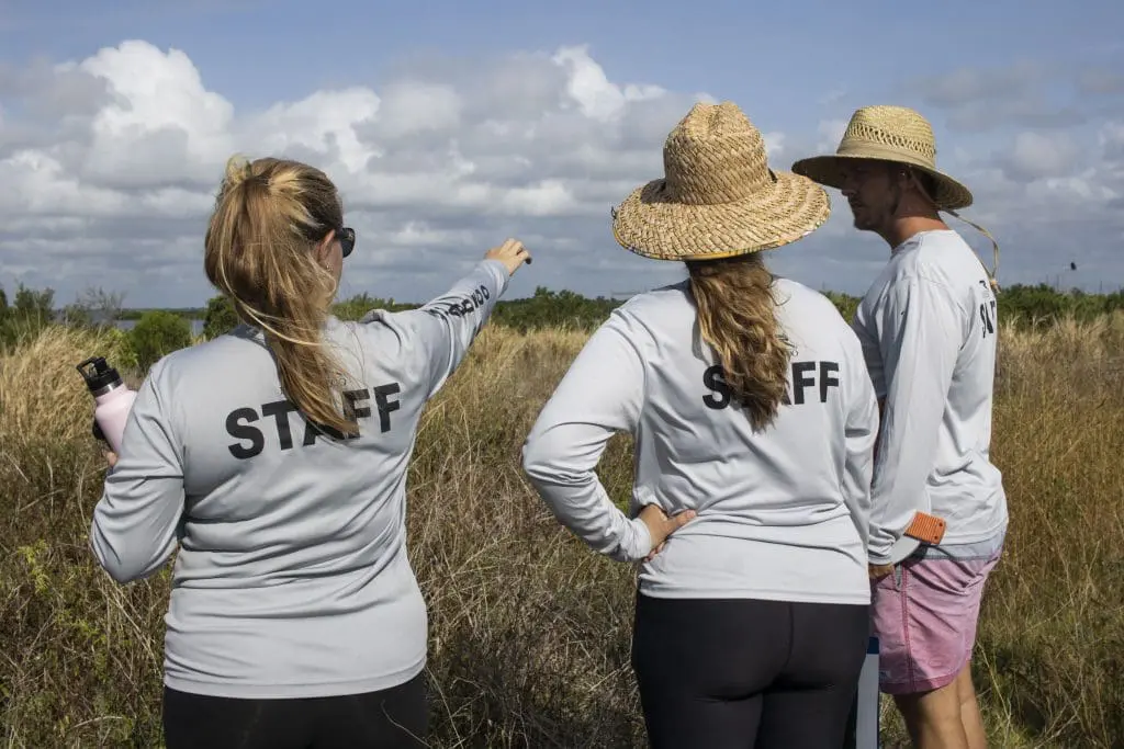 Three Restore Our Shores staff members look at the site of Brevard Zoo's future aquarium