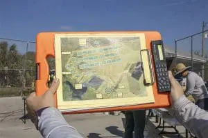 Construction of a seagrass nursery begins as a staff member holds up a blueprint.