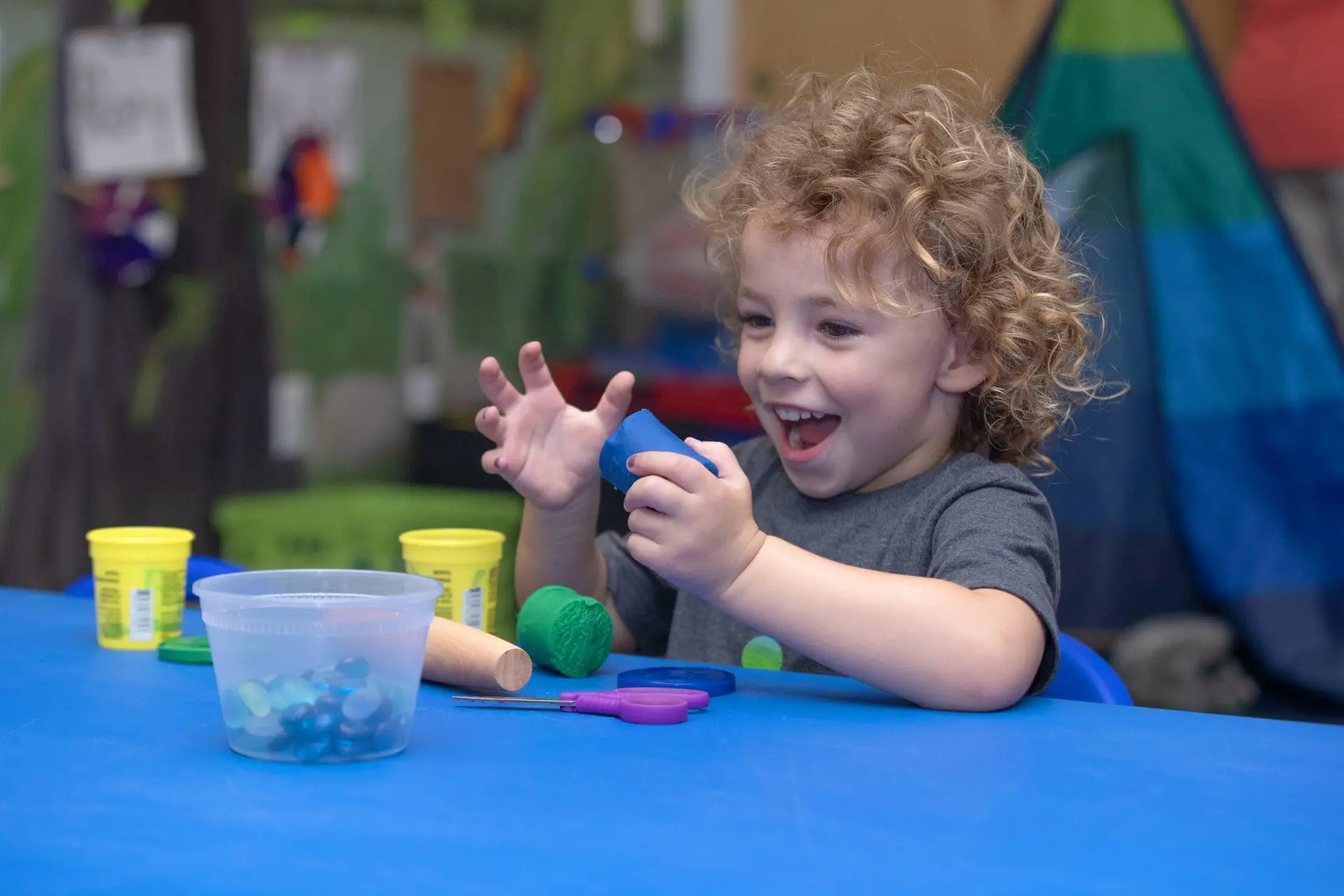 A preschooler plays with blocks