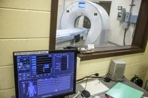 A look a the diagnostic screen of a CT with machine in the background.
