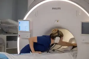 A veterinary technician checks on a white-nosed coati in an MRI