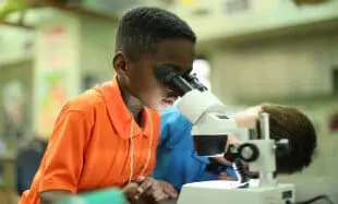 Boy looking through microscope