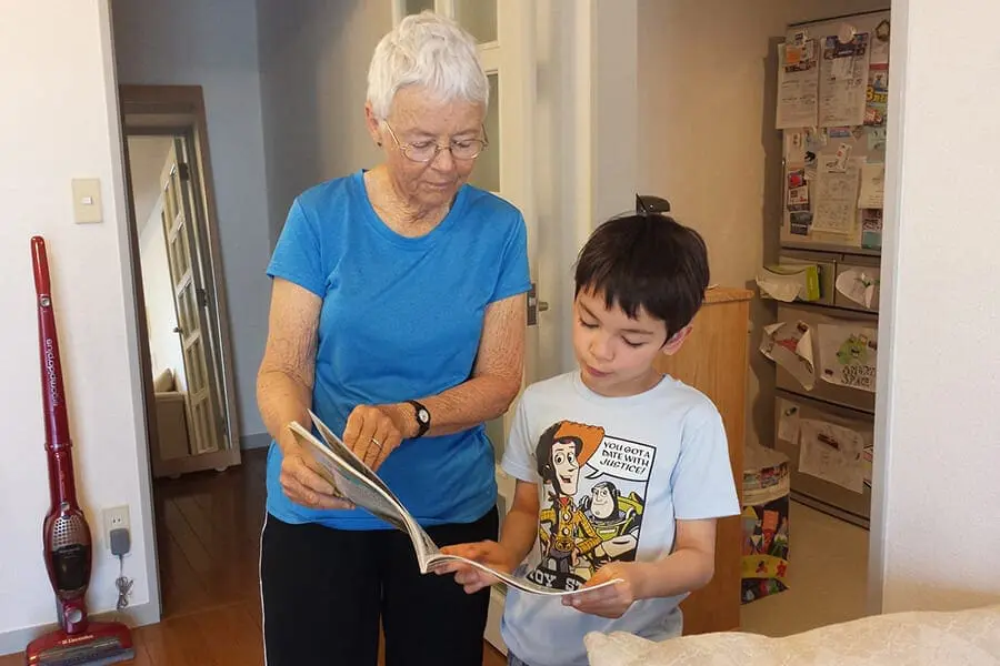 Adult and child looking at a book