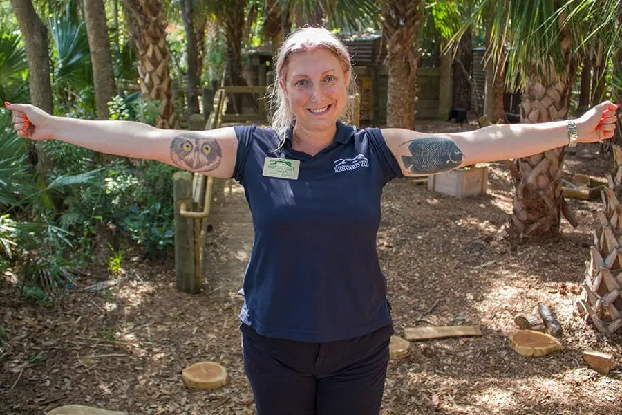 Education specialist Sarah with owl and fish tattoos