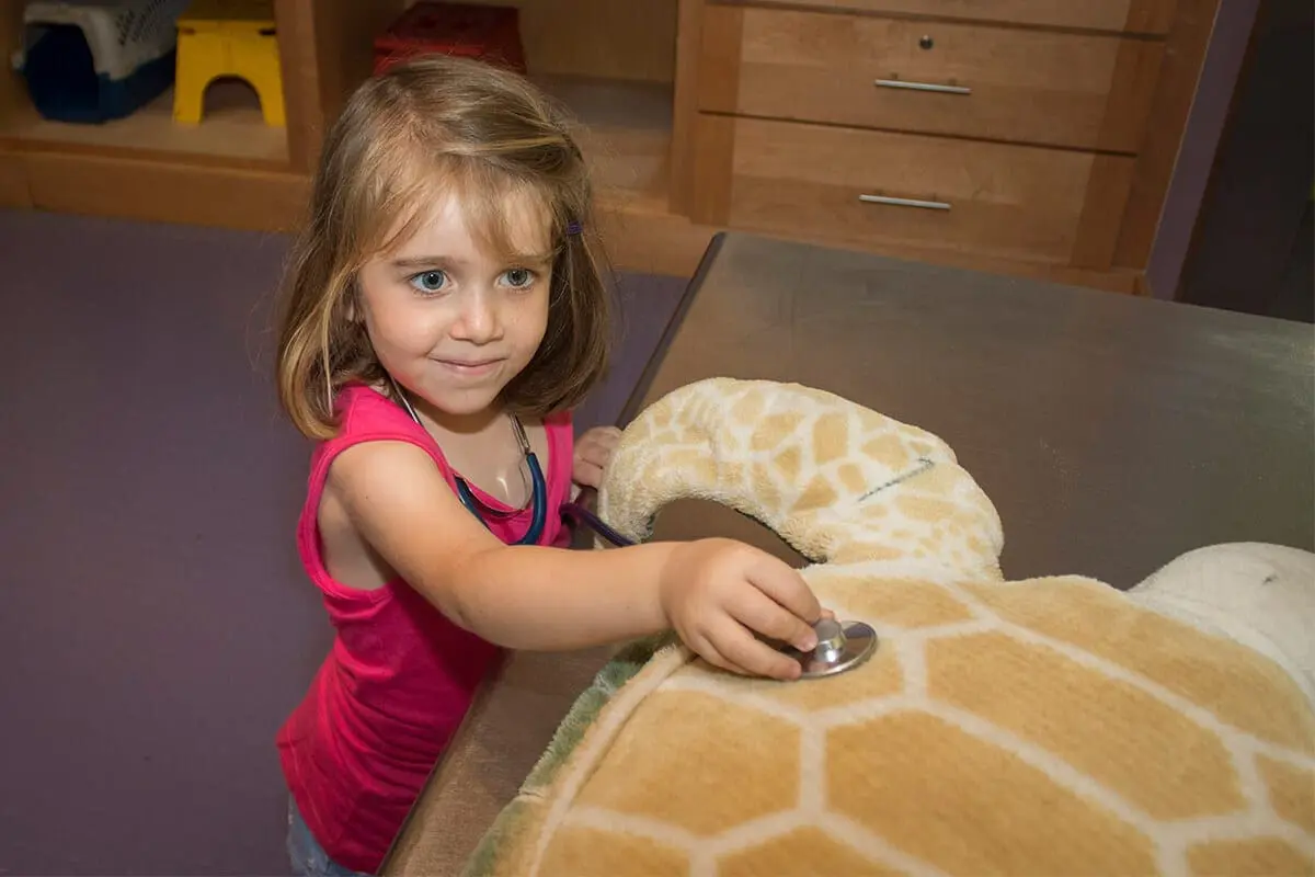 A young girl playing with toys at the WDTA