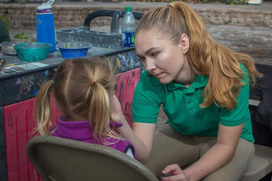 Zoo teen painting child's face