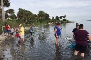 family dip netting in the Indian River Lagoon
