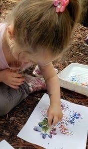 Child painting with flower