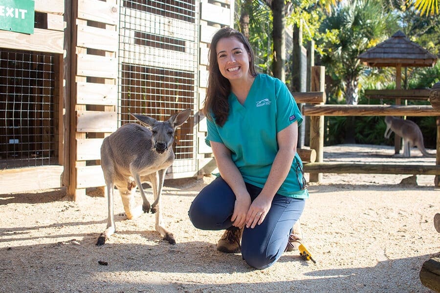 Veterinarian Kyle Donnelly poses next to a kangaroo