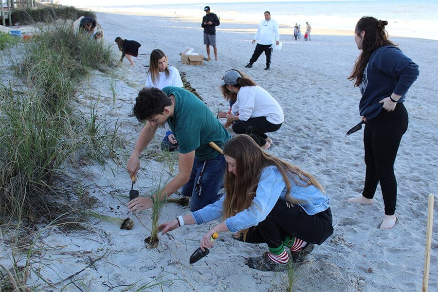 Zoo Teens planting sea oats