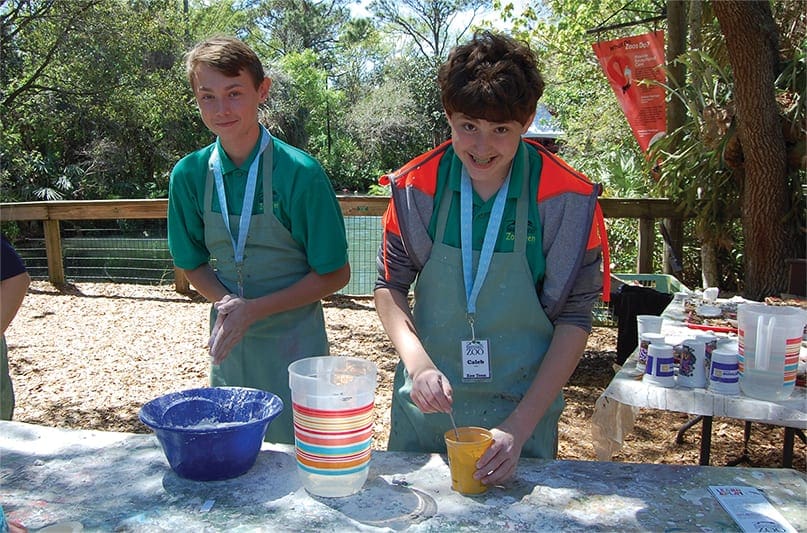 Two young boys making lemonade.