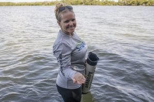 Director of Conservation holds up seagrass