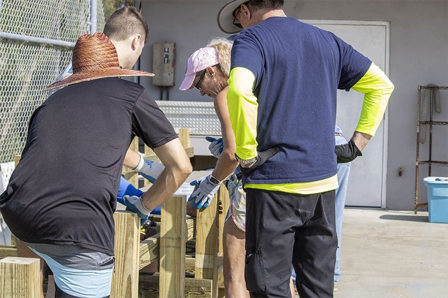 Construction of a seagrass nursery begins as volunteers create the tank stands.