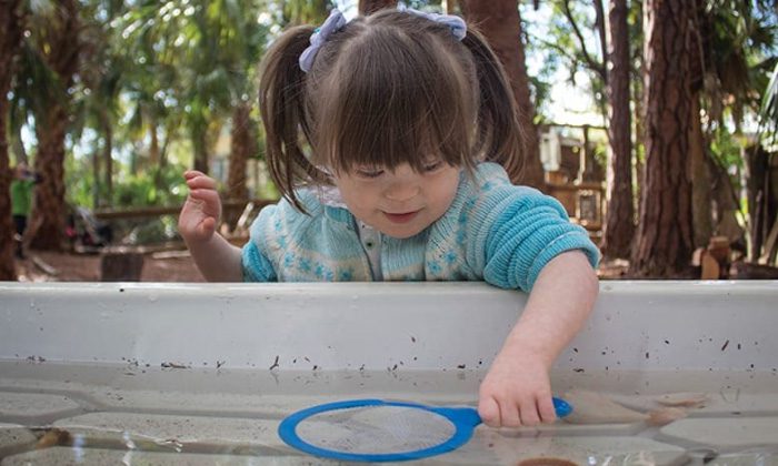 young girl with magnifying glass