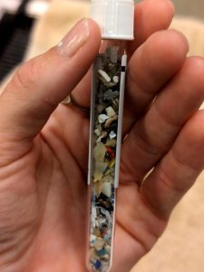 a test tube filled with small pieces of plastic