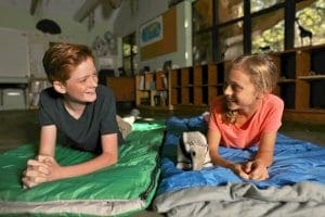 Kids in sleeping bags during overnight program