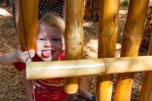 Young boy making silly faces in play area